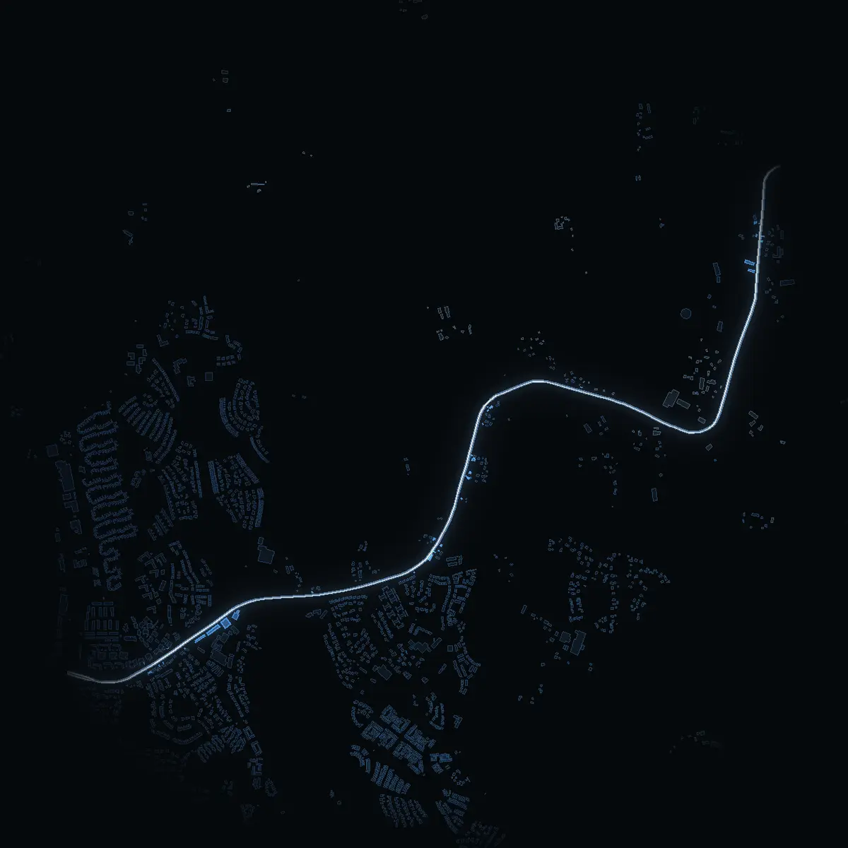 The street at night: Vallentunavägen drawn in white, its buildings lit in the colour of their area’s income